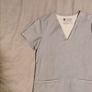 Two pocket scrub top. FIGS.